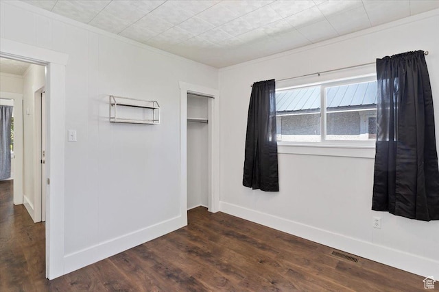 73 E 400 S, Logan, UT 84321 - unfurnished bedroom with crown molding, dark wood-style floors, a closet, and baseboards