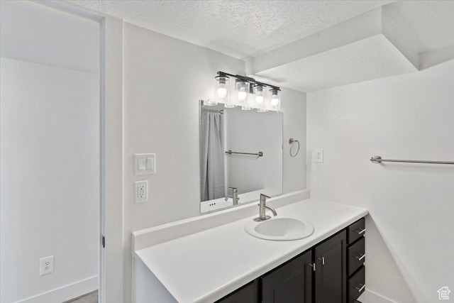 73 E 400 S, Logan, UT 84321 - bathroom with a textured ceiling, vanity, and baseboards