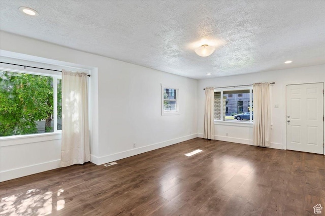 73 E 400 S, Logan, UT 84321 - empty room featuring a textured ceiling, baseboards, wood finished floors, and recessed lighting