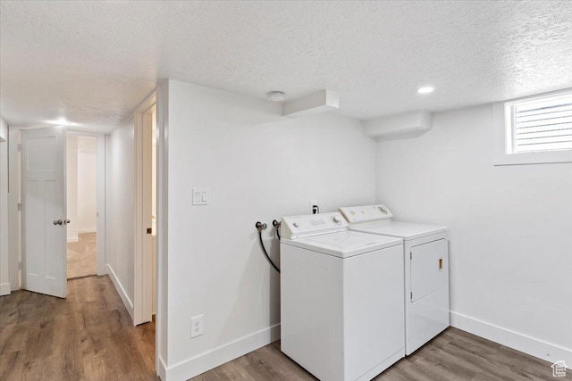 73 E 400 S, Logan, UT 84321 - laundry area featuring a textured ceiling, washer and dryer, baseboards, and wood finished floors