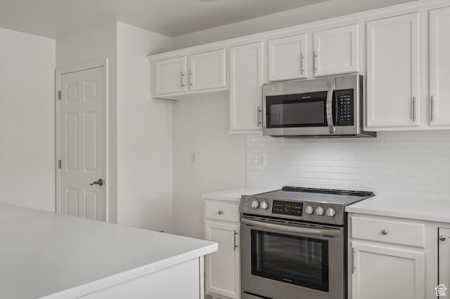 5094 W Pebblerock Cir S, West Jordan, UT 84081 - kitchen featuring stainless steel appliances, light countertops, backsplash, and white cabinets