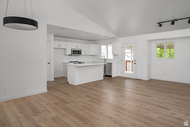 5094 W Pebblerock Cir S, West Jordan, UT 84081 - kitchen with stainless steel appliances, white cabinetry, open floor plan, light countertops, and a sink