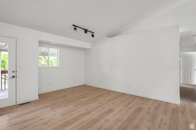5094 W Pebblerock Cir S, West Jordan, UT 84081 - unfurnished room with rail lighting, light wood-type flooring, baseboards, and lofted ceiling