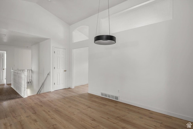 5094 W Pebblerock Cir S, West Jordan, UT 84081 - empty room featuring wood finished floors, high vaulted ceiling, and baseboards