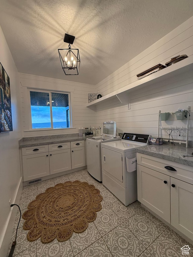 268 N 1400 W, Midway, UT 84049 - laundry room with washing machine and dryer, cabinet space, a textured ceiling, a chandelier, and light tile patterned floors
