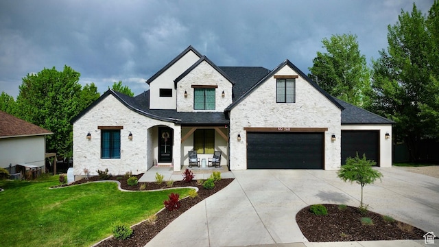 268 N 1400 W, Midway, UT 84049 - view of front of property with a porch, stone siding, a front lawn, concrete driveway, and stucco siding