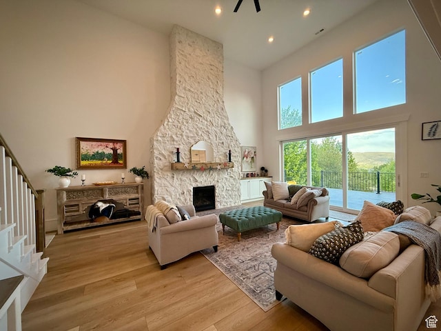 268 N 1400 W, Midway, UT 84049 - living room with a towering ceiling, light wood-style floors, a stone fireplace, stairway, and recessed lighting