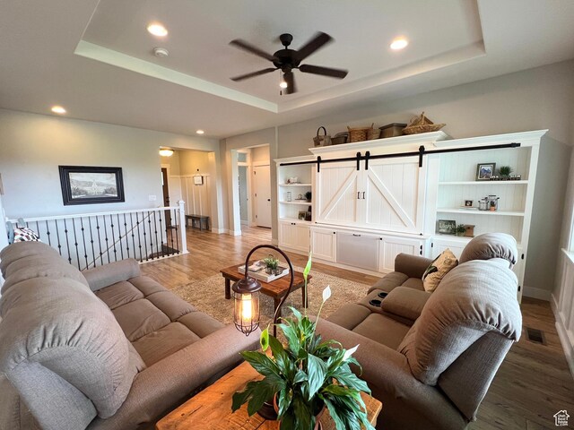 12137 N Montrose Dr, Highland, UT 84003 - living area with a tray ceiling, ceiling fan, light wood-type flooring, recessed lighting, and baseboards