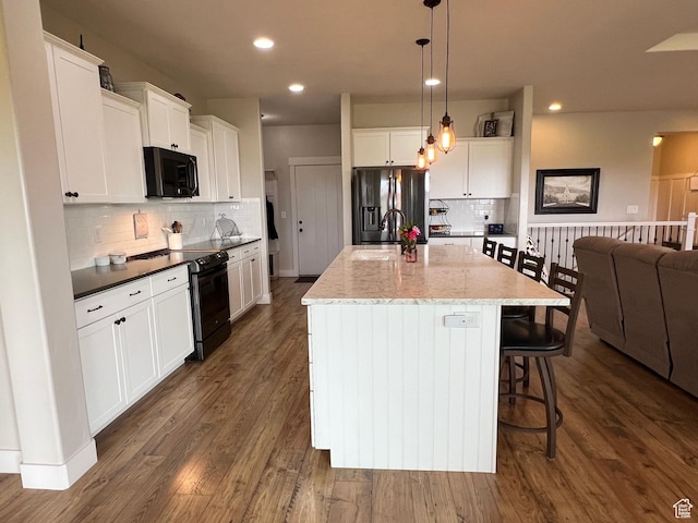 12137 N Montrose Dr, Highland, UT 84003 - kitchen with stainless steel fridge, black / electric stove, a sink, decorative backsplash, and white cabinets