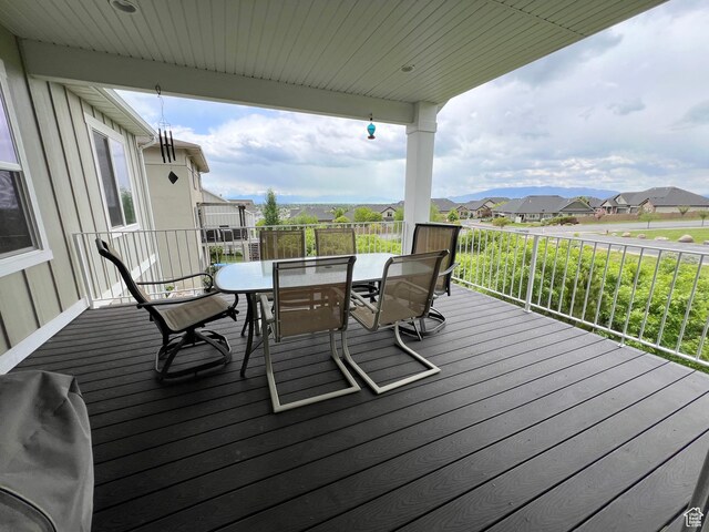 12137 N Montrose Dr, Highland, UT 84003 - wooden terrace featuring outdoor dining area and a residential view