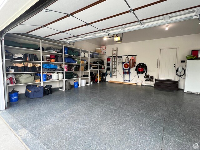 12137 N Montrose Dr, Highland, UT 84003 - garage with freestanding refrigerator and a garage door opener