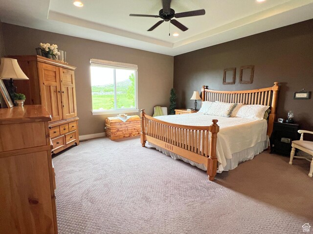 12137 N Montrose Dr, Highland, UT 84003 - bedroom featuring light colored carpet, recessed lighting, a tray ceiling, a ceiling fan, and baseboards