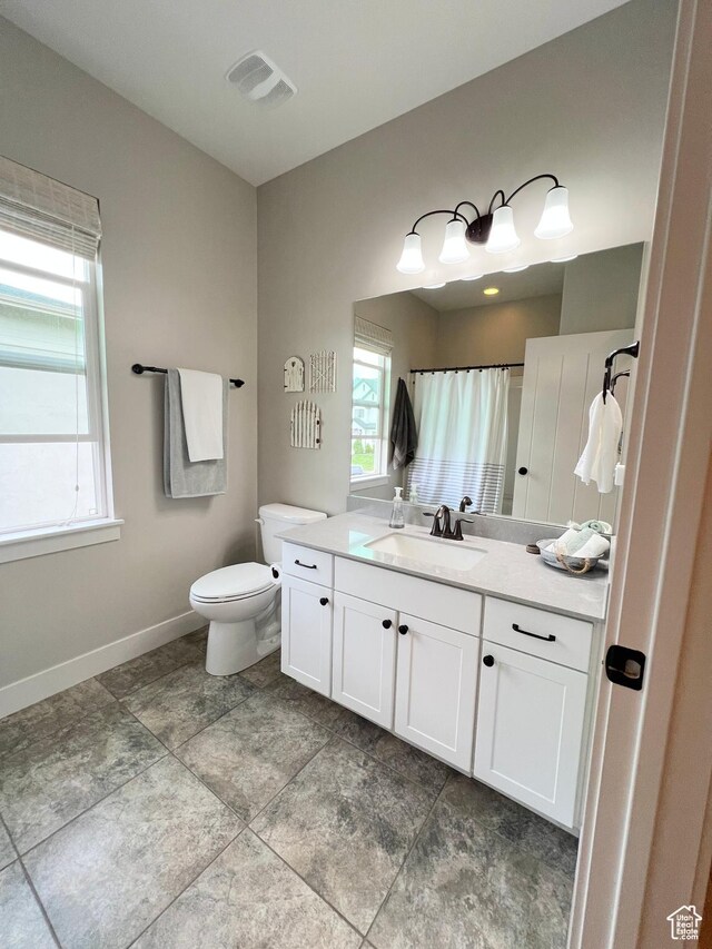 12137 N Montrose Dr, Highland, UT 84003 - full bathroom featuring toilet, vanity, baseboards, and curtained shower