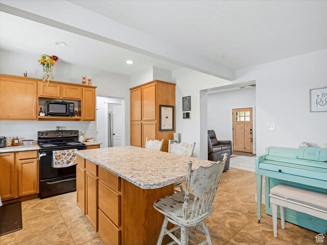 6692 S 3200 W, Benjamin, UT 84660 - kitchen featuring black appliances, a kitchen island, light countertops, a kitchen bar, and recessed lighting