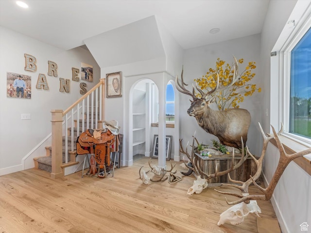 6692 S 3200 W, Benjamin, UT 84660 - living area featuring arched walkways, wood finished floors, stairs, and baseboards