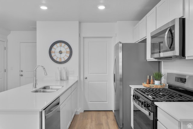 122 N Seaside St Unit 2319, Saratoga Springs, UT 84045 - kitchen featuring appliances with stainless steel finishes, a sink, a peninsula, light countertops, and recessed lighting