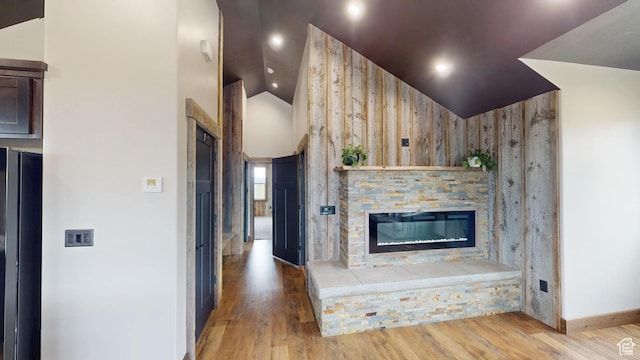 1164 S 1600 E, Preston, ID 83263 - unfurnished living room featuring vaulted ceiling, a fireplace, wood finished floors, and baseboards