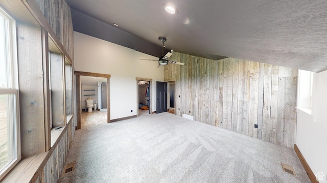 1164 S 1600 E, Preston, ID 83263 - carpeted spare room with wooden walls, vaulted ceiling, baseboards, and a ceiling fan