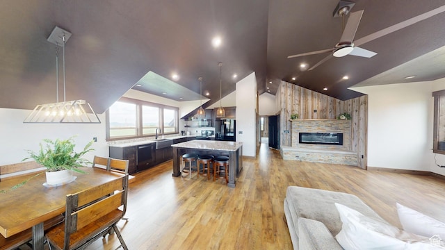 1164 S 1600 E, Preston, ID 83263 - living room featuring lofted ceiling, light wood finished floors, a ceiling fan, a fireplace, and baseboards