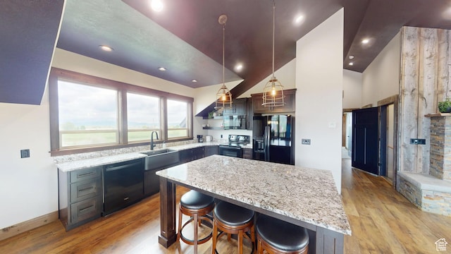 1164 S 1600 E, Preston, ID 83263 - kitchen with black appliances, a sink, light wood finished floors, a center island, and recessed lighting