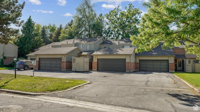 3263 Shadowbrook Cir N, Provo, UT 84604 - view of front facade with brick siding, a front yard, driveway, and an attached garage