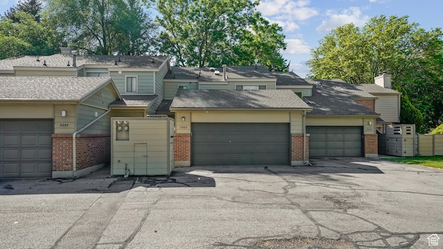 3263 Shadowbrook Cir N, Provo, UT 84604 - townhome / multi-family property featuring brick siding, an attached garage, and driveway