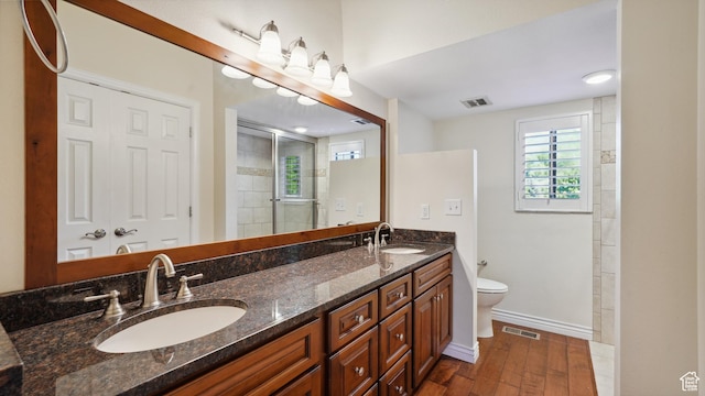 3263 Shadowbrook Cir N, Provo, UT 84604 - bathroom featuring toilet, wood finished floors, double vanity, baseboards, and tiled shower