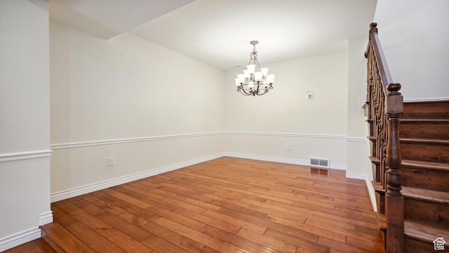 3263 Shadowbrook Cir N, Provo, UT 84604 - unfurnished dining area with wood-type flooring, stairs, baseboards, and a chandelier