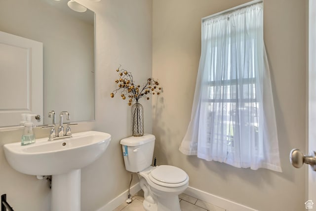 2466 S 2200 W, West Haven, UT 84401 - bathroom featuring toilet, tile patterned flooring, baseboards, and a sink