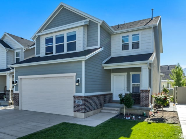 2466 S 2200 W, West Haven, UT 84401 - craftsman house with brick siding, an attached garage, concrete driveway, and a front yard