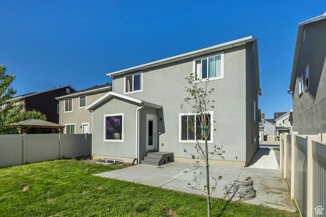 2466 S 2200 W, West Haven, UT 84401 - rear view of property featuring stucco siding and a patio