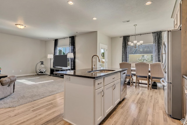2466 S 2200 W, West Haven, UT 84401 - kitchen with stainless steel appliances, a sink, a chandelier, open floor plan, and recessed lighting