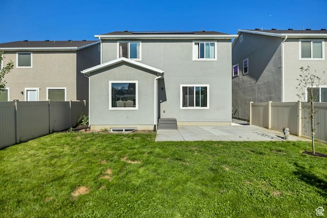 2466 S 2200 W, West Haven, UT 84401 - back of house featuring solar panels, stucco siding, and a patio area