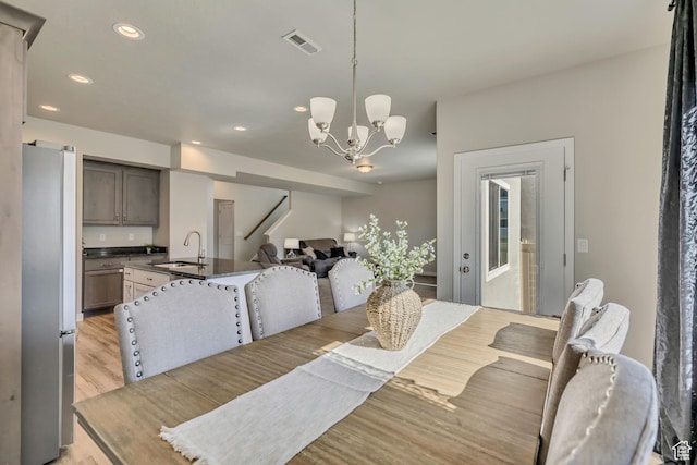 2466 S 2200 W, West Haven, UT 84401 - dining space with light wood-type flooring, recessed lighting, and a chandelier