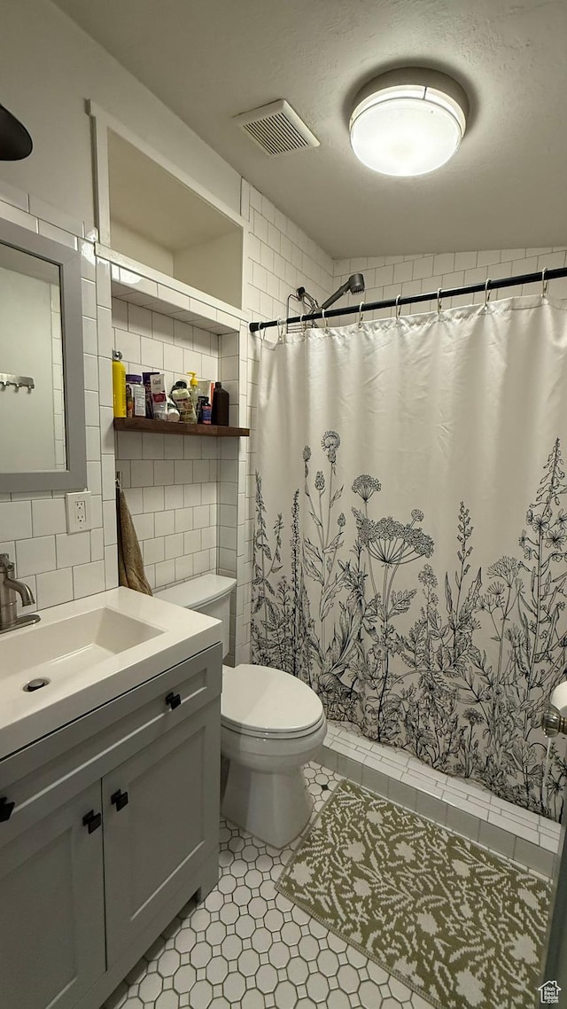 161 W 200 S, Provo, UT 84601 - bathroom with vanity, toilet, curtained shower, tasteful backsplash, and tile walls