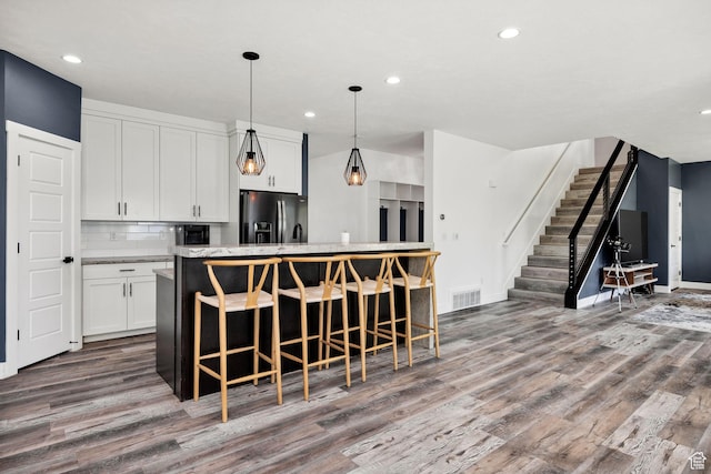 181 W 400 S, Hyrum, UT 84319 - kitchen featuring refrigerator with ice dispenser, wood finished floors, a center island, recessed lighting, and white cabinets