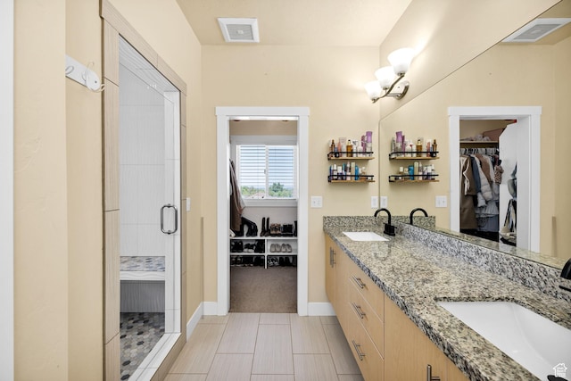 181 W 400 S, Hyrum, UT 84319 - bathroom featuring a spacious closet, double vanity, a stall shower, and baseboards