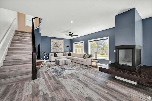 181 W 400 S, Hyrum, UT 84319 - living area featuring stairs, wood finished floors, ceiling fan, a multi sided fireplace, and recessed lighting