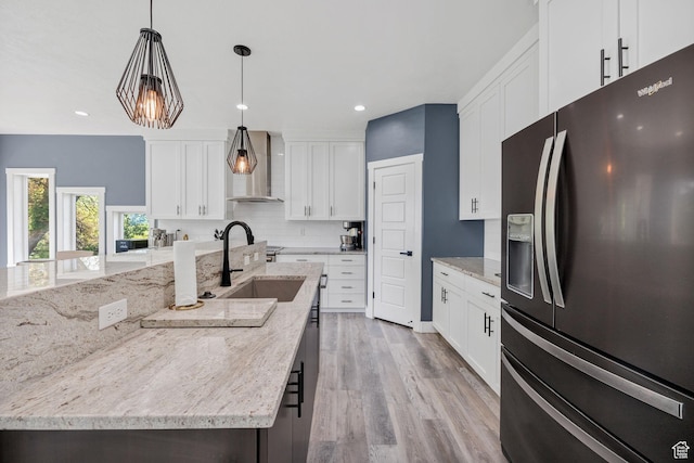 181 W 400 S, Hyrum, UT 84319 - kitchen featuring fridge with ice dispenser, wall chimney exhaust hood, tasteful backsplash, a sink, and a spacious island