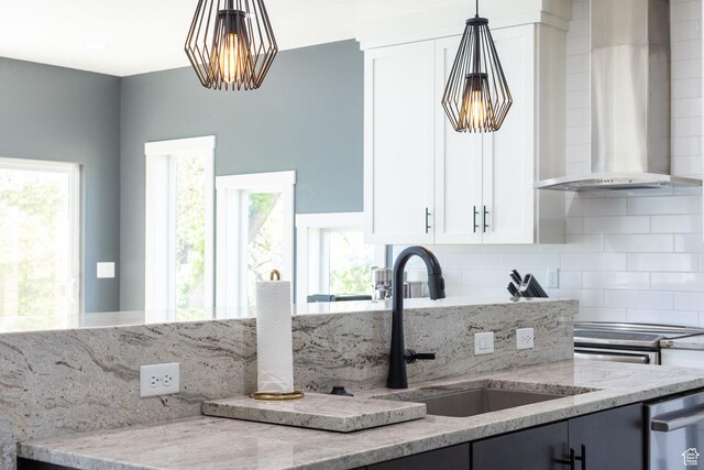 181 W 400 S, Hyrum, UT 84319 - kitchen with wall chimney exhaust hood, a sink, light stone counters, and decorative backsplash