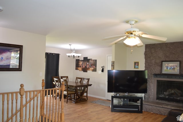 445 Valley View Dr, Pleasant Grove, UT 84062 - living area with light wood-type flooring, a chandelier, ceiling fan, baseboards, and a fireplace