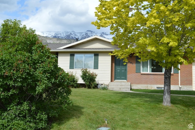 445 Valley View Dr, Pleasant Grove, UT 84062 - view of front of home featuring entry steps, a front lawn, brick siding, and a mountain view