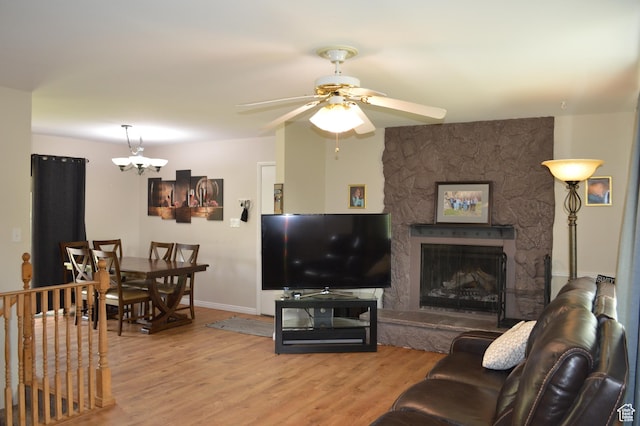445 Valley View Dr, Pleasant Grove, UT 84062 - living area with light wood-style flooring, ceiling fan, baseboards, a fireplace, and a chandelier