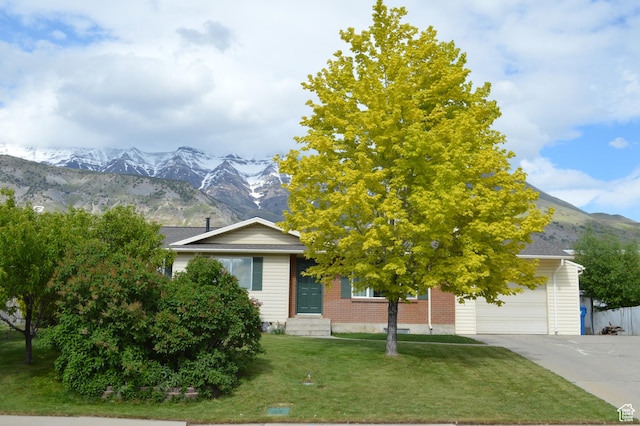 445 Valley View Dr, Pleasant Grove, UT 84062 - view of front of house with a mountain view, a garage, concrete driveway, entry steps, and brick siding