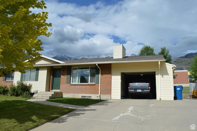 445 Valley View Dr, Pleasant Grove, UT 84062 - ranch-style house with a chimney, an attached garage, driveway, brick siding, and a mountain view