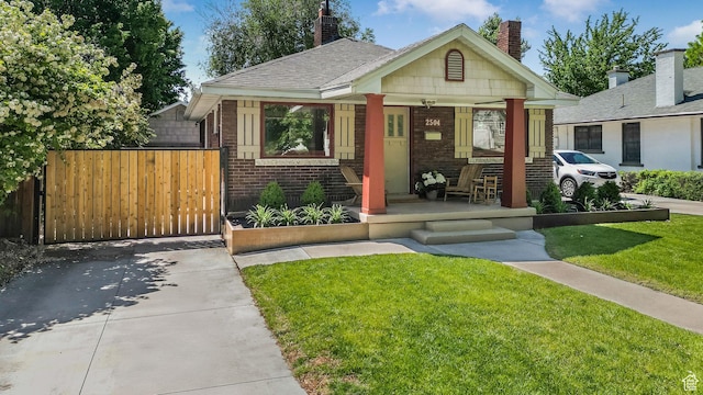 2504 S Dearborn St E, Salt Lake City, UT 84106 - bungalow-style house featuring covered porch, brick siding, and a chimney