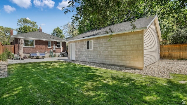 2504 S Dearborn St E, Salt Lake City, UT 84106 - back of house featuring a patio area, an outdoor structure, and brick siding