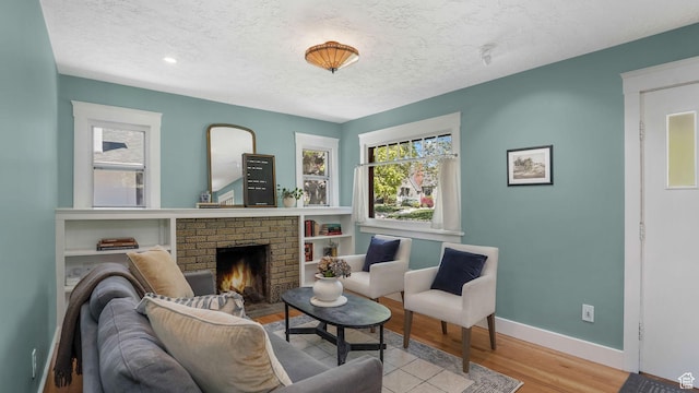 2504 S Dearborn St E, Salt Lake City, UT 84106 - living room featuring a textured ceiling, baseboards, wood finished floors, and a fireplace