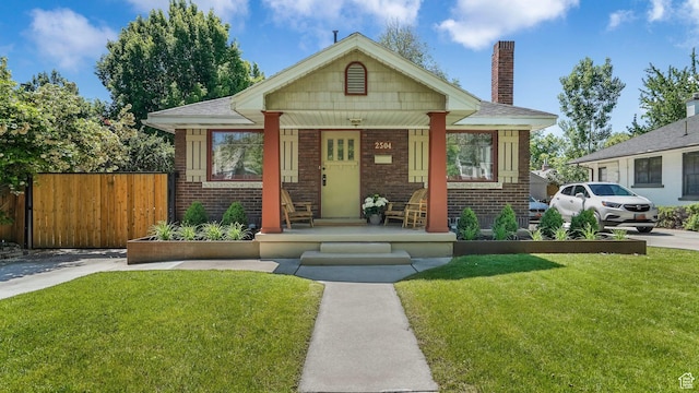 2504 S Dearborn St E, Salt Lake City, UT 84106 - bungalow-style home featuring brick siding, a porch, and a chimney