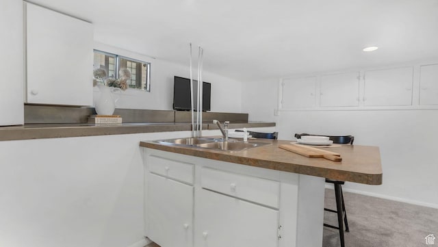 2504 S Dearborn St E, Salt Lake City, UT 84106 - kitchen featuring a sink, white cabinetry, a breakfast bar, and recessed lighting